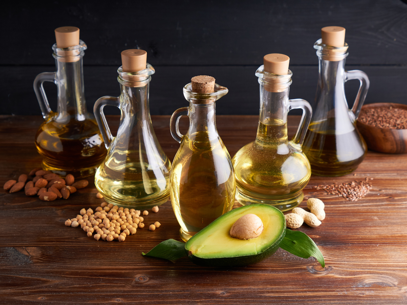various oils in glass containers on a wooden table